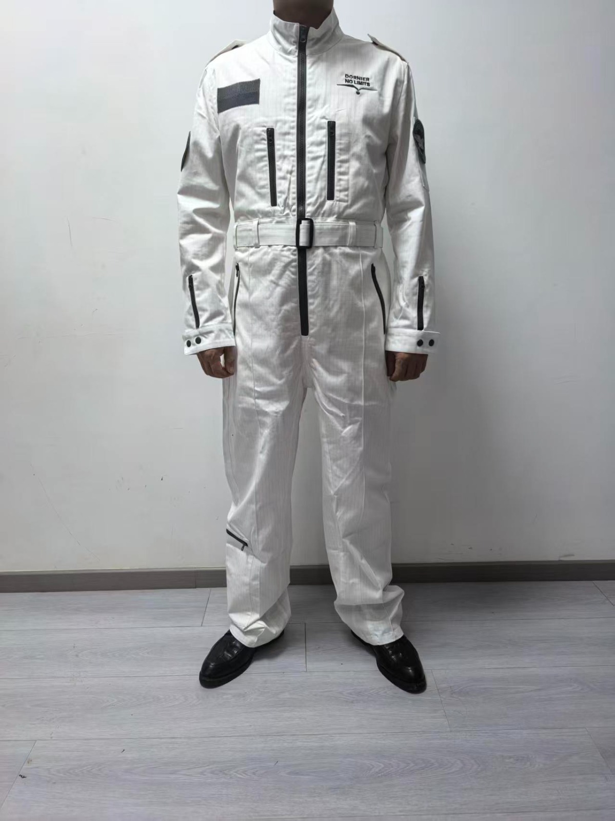 Real white flight suit sample with offset chest zip pockets, sleeve pockets and a leg pocket