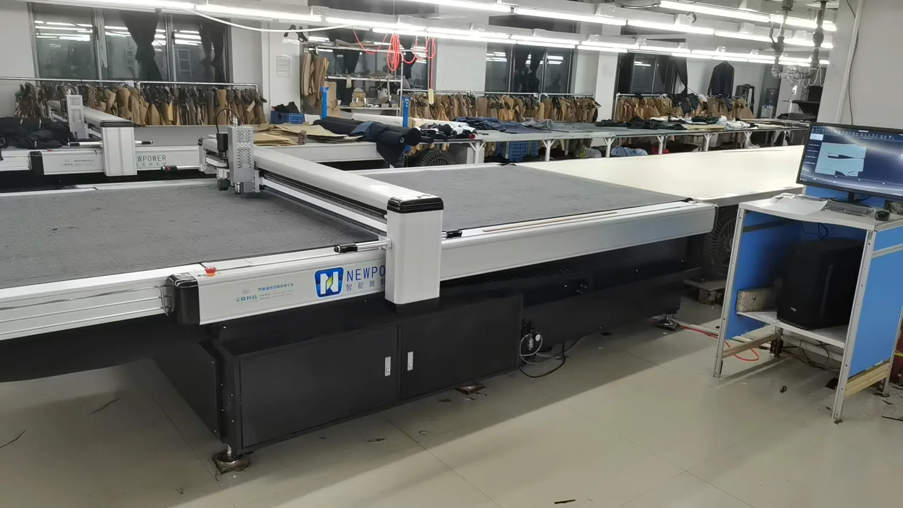 Automated fabric cutting table in a production partner facility