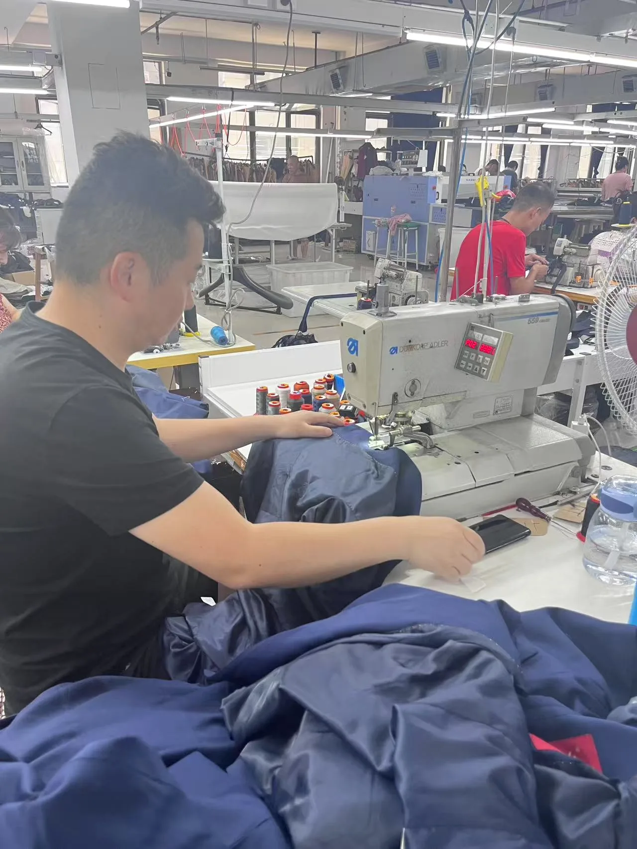 Operator sewing reinforced garment construction